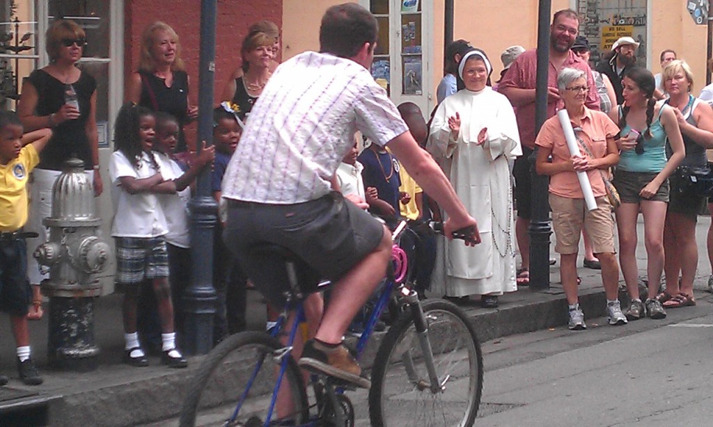 Guy on bike passes nun on street